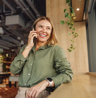 Woman smiling while talking on phone
