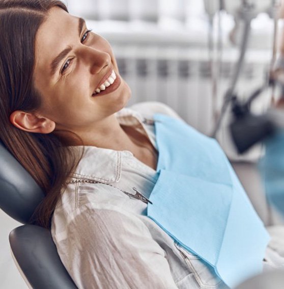 a patient smiling while visiting her dentist
