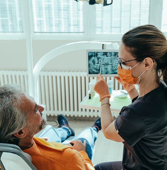 man at consultation about dental bridge