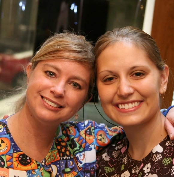 Two team members smiling after providing personalized dental treatment plans