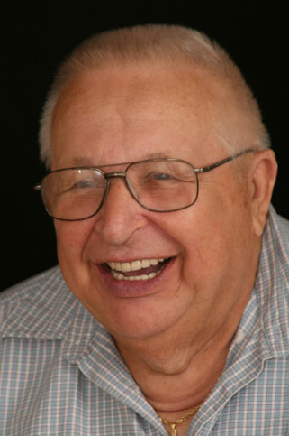 Older man sharing healthy smile crafted by dentures