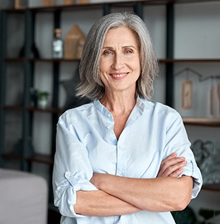 Woman with dental implants in Kittanning, PA folding her arms