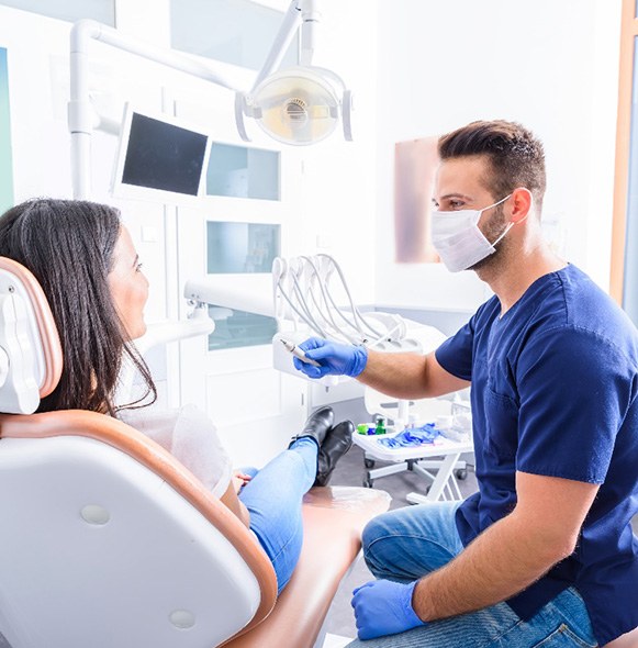 A dentist explaining how a smile makeover works to his patient