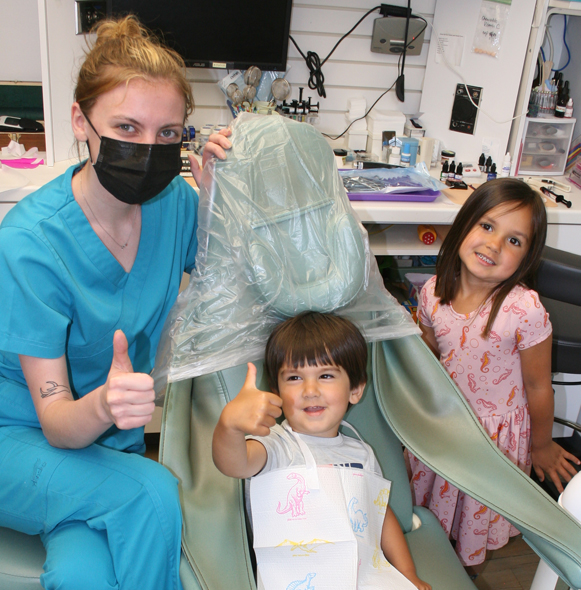 Dentist giving thumbs up after providing sedation dentistry for kids