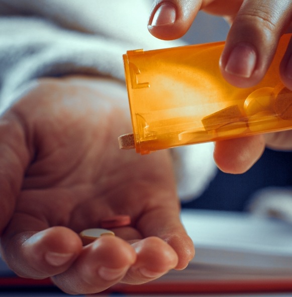 Closeup of patient pouring out pills for oral conscious sedation in Kittanning