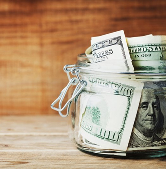 Jar of money on a wood surface 