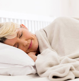 Woman sleeping with a cozy blanket