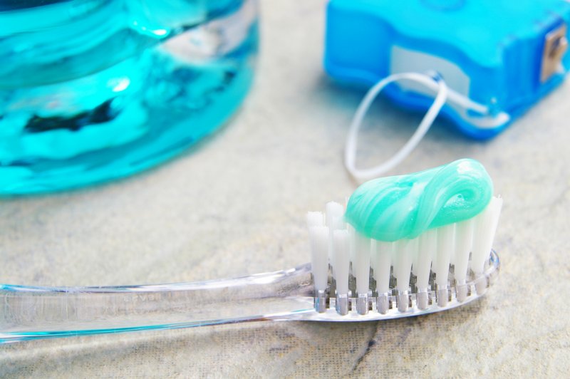 Toothbrush with toothpaste, dental floss, and mouthwash