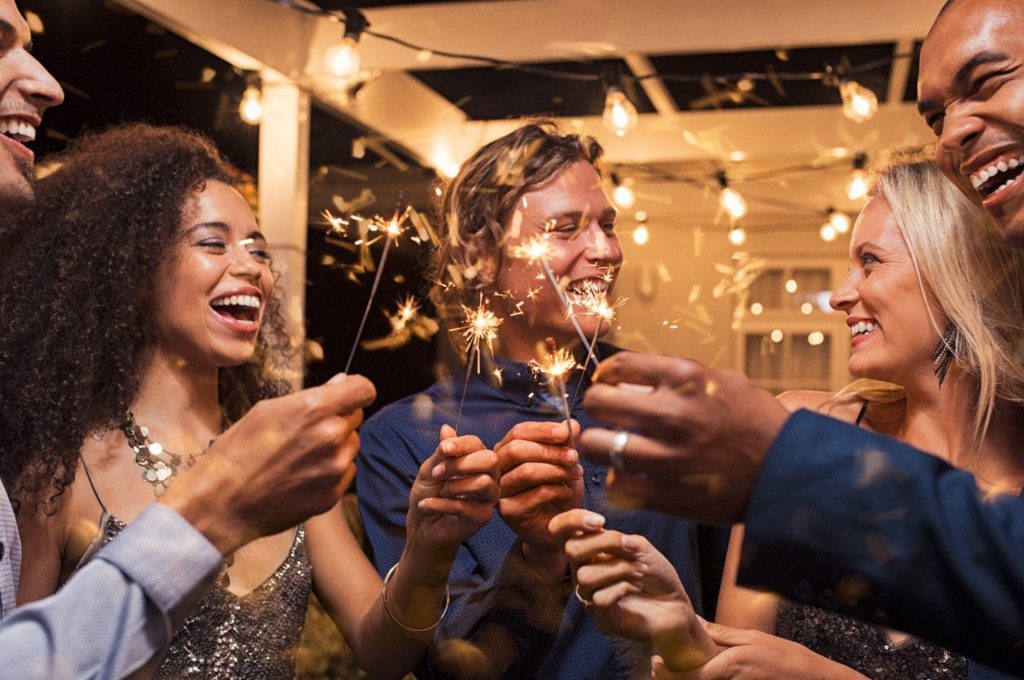 Friends with sparklers on New Year's Eve