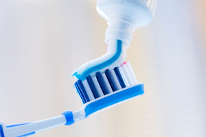 Close-up of squeezing toothpaste onto a toothbrush