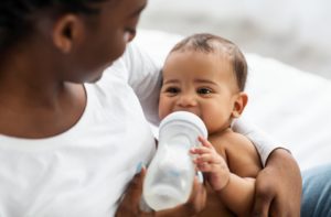 mother bottle feeding baby 