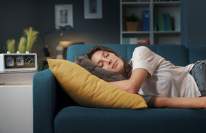 Woman lying on couch taking a nap